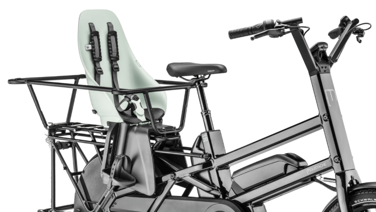Electric cargo bike with child seat on rear rack.