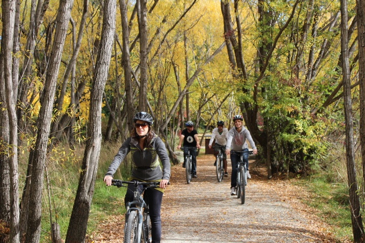 Group biking on a forest trail in autumn