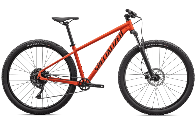 Red mountain bike with black tires and 'SPECIALIZED' on the frame.